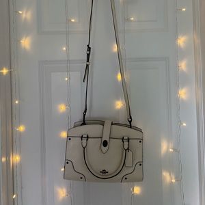 cream/white leather Coach purse with black lining